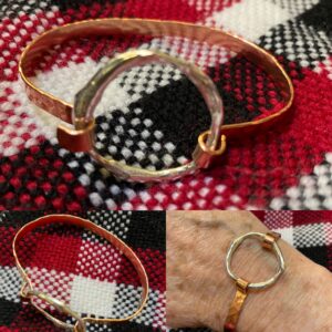 Silver is melted down into an organic open ring shape and then attached to a flat copper band and made into a bracelet